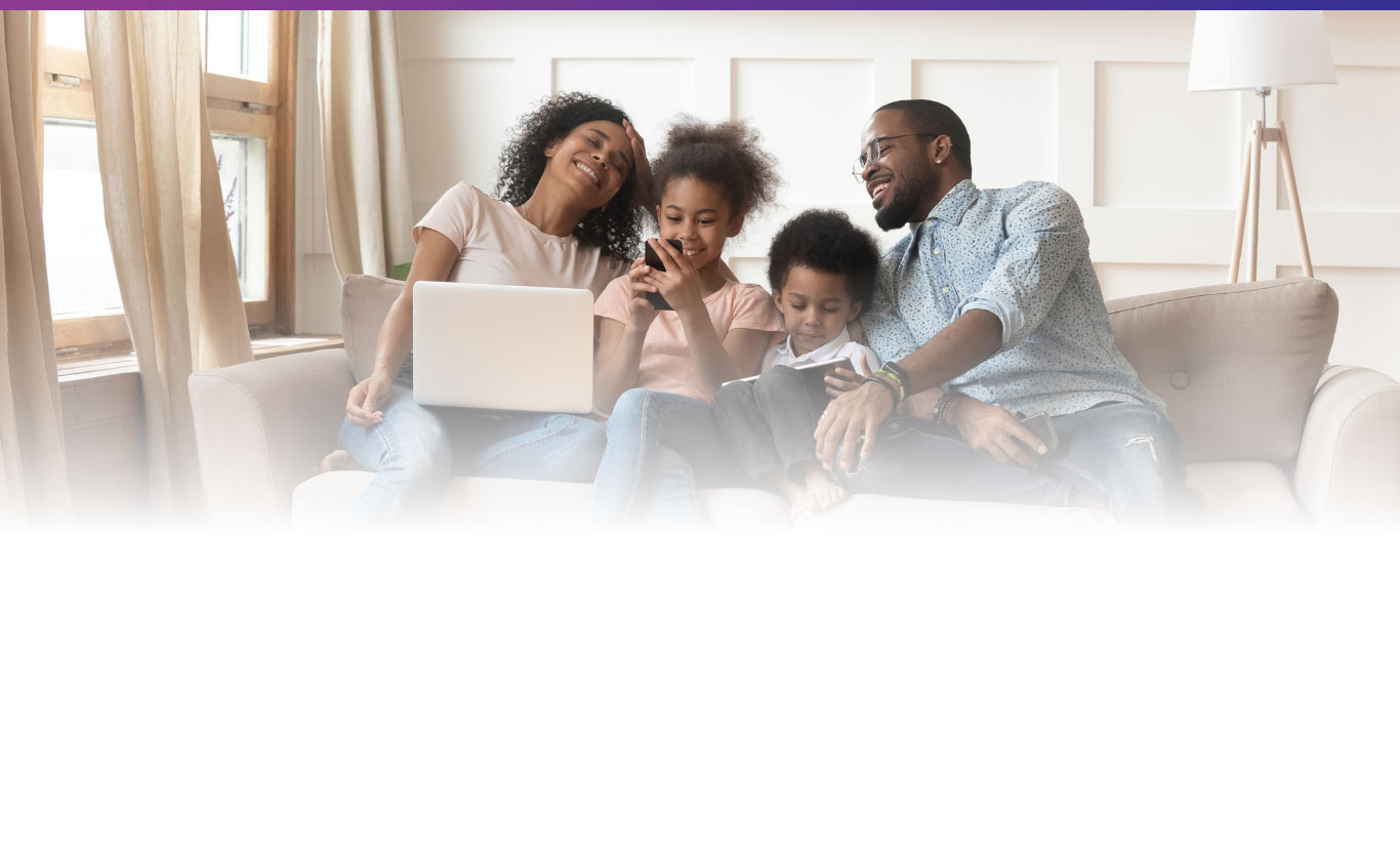 family on couch using wireless devices