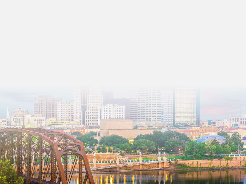 A view of the city of Shreveport, LA including a glimpse of a lake and bridge