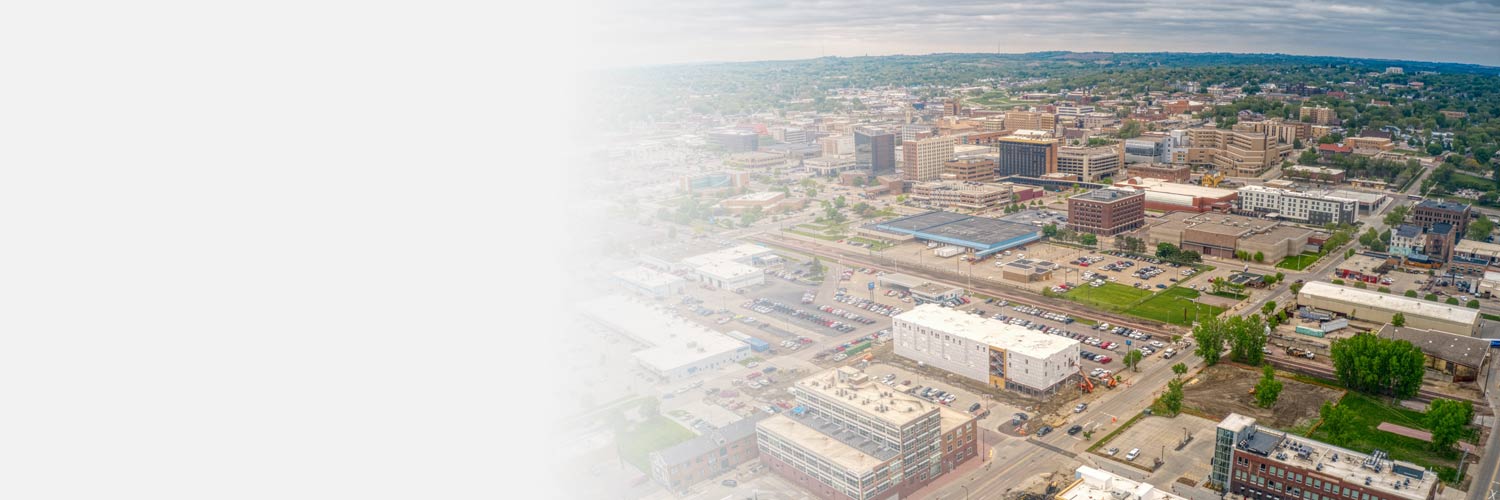 A sky view of Sioux City, IA that shows buildings, trees, streets, and cars