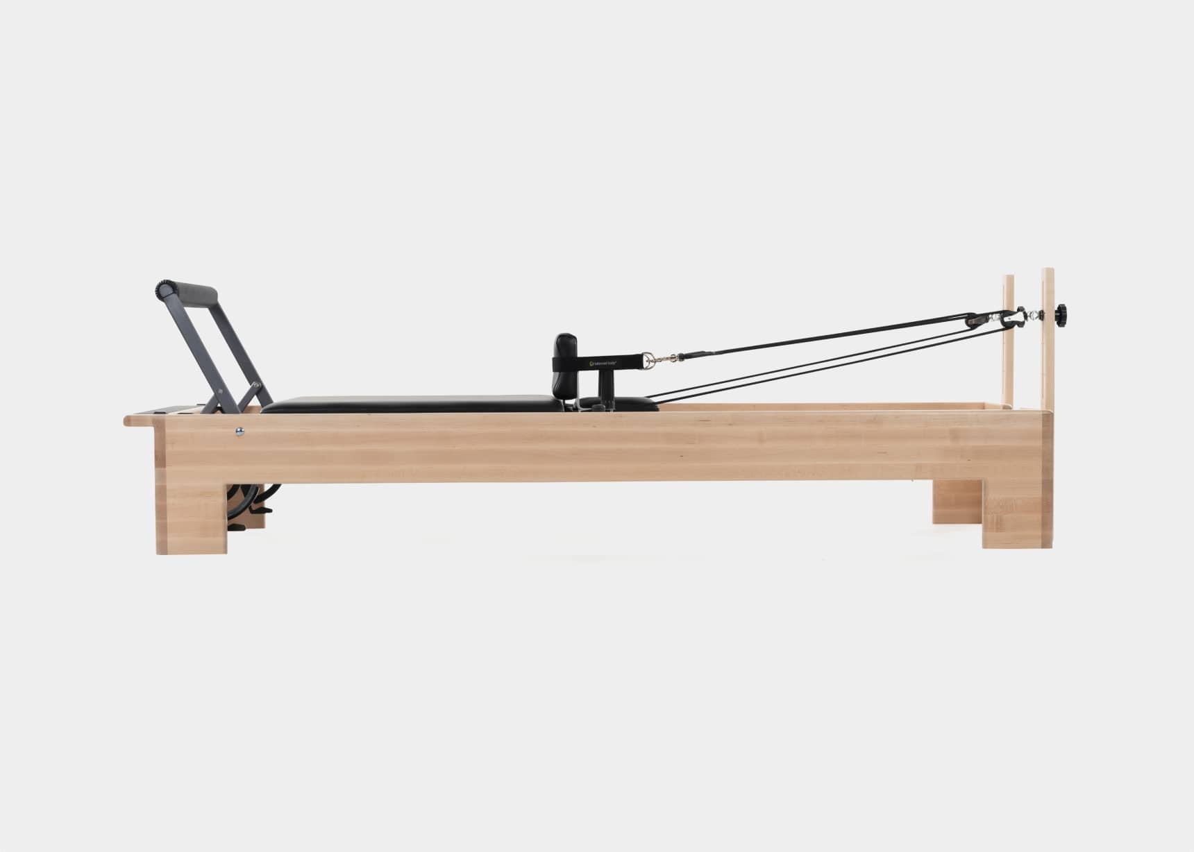 Side view of a Pilates studio reformer.