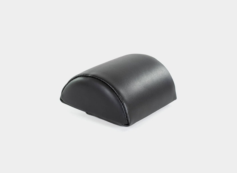 Single black half-cylinder cushion for support.