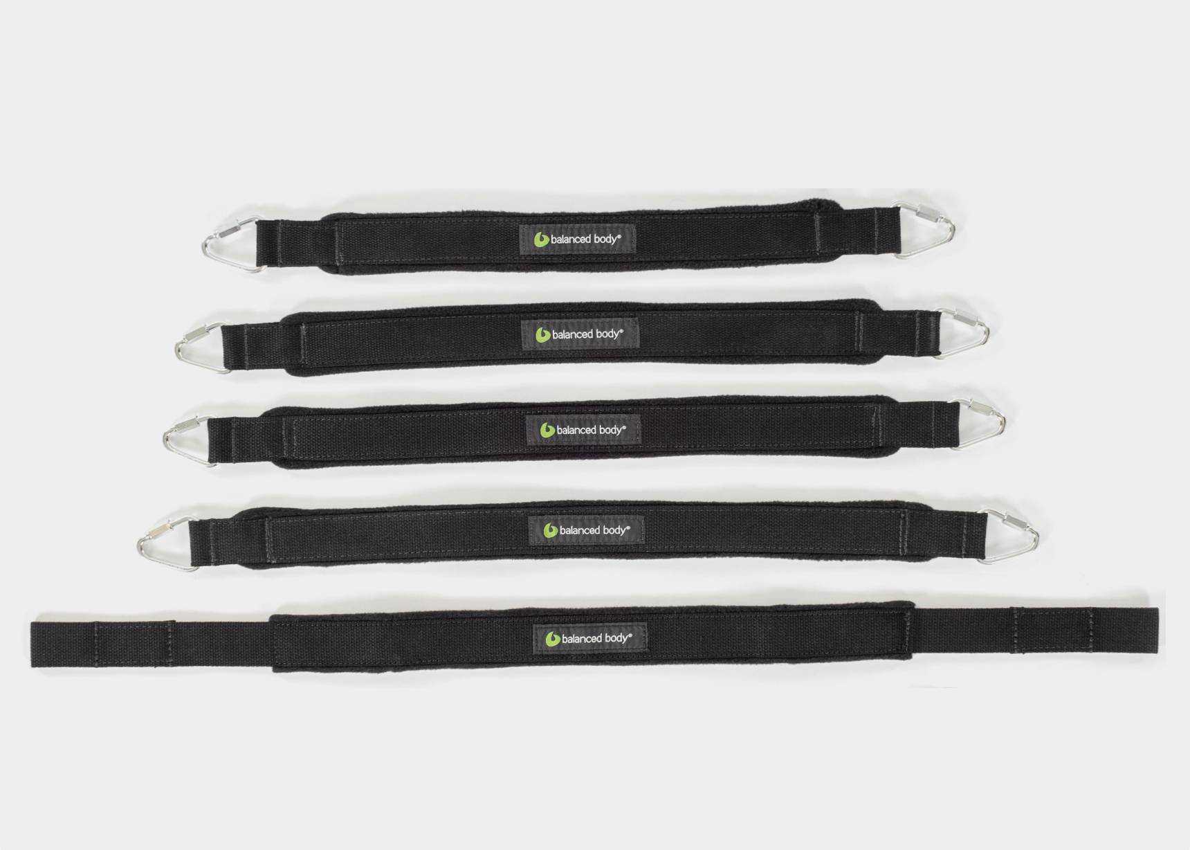 Black padded foot straps for Pilates exercises. 