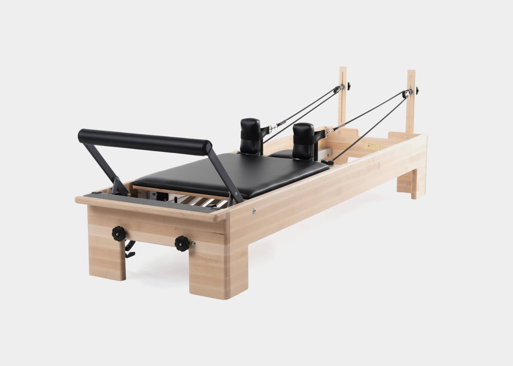 Side view of a fully set up Pilates Studio Reformer.