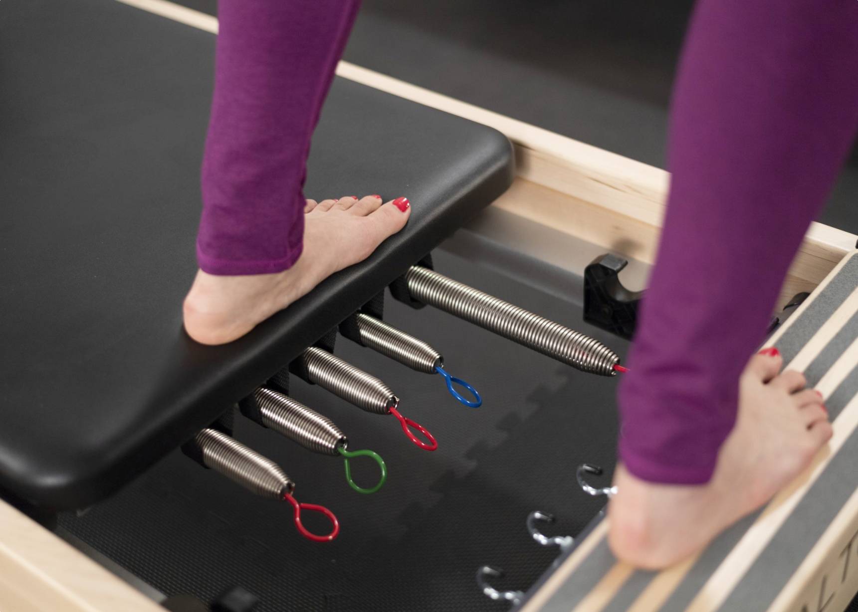 A zoomed-in snapshot showcasing the craftsmanship of signature springs on a Pilates reformer.