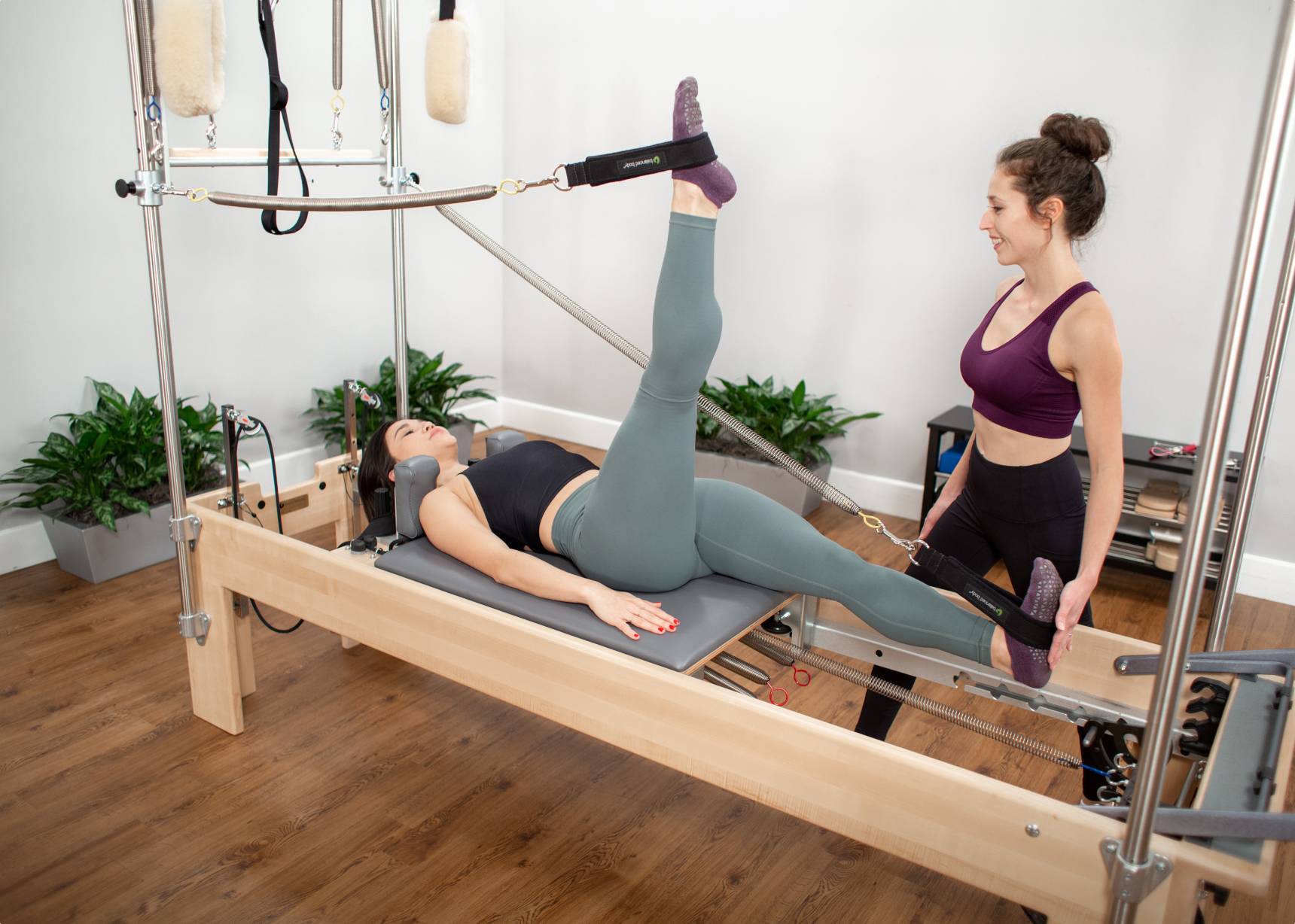 Woman using the reformer trapeze combination 