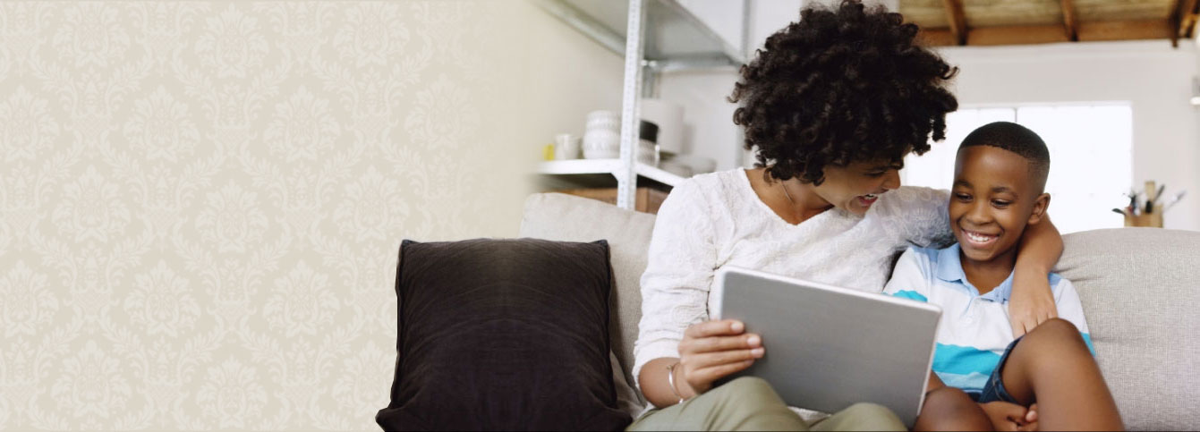 smiling parent and child playing on tablet